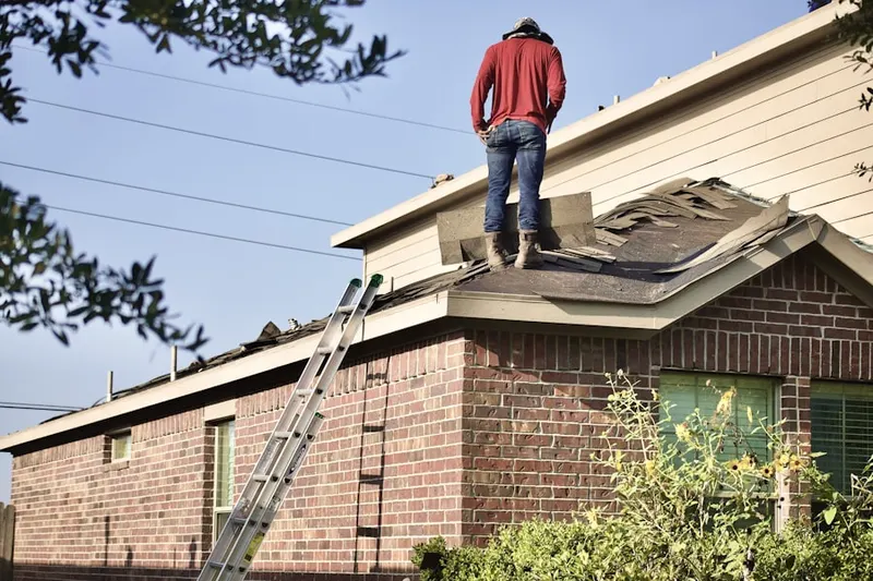 Professional roofer working on a residential roof in North Haledon